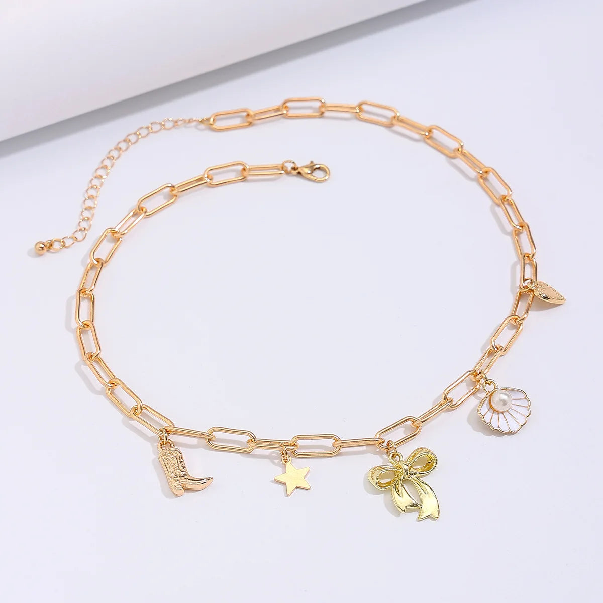 Collier breloque noeud papillon doré
