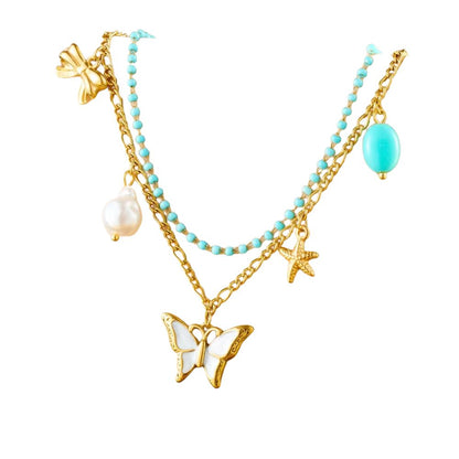 Double collier à breloques doré avec papillon blanc et perle