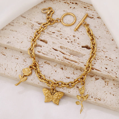 Bracelet breloques avec papillon doré à bascule