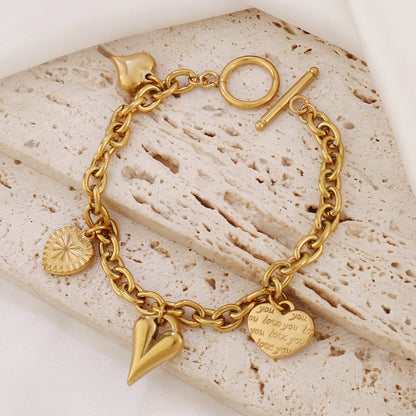 Bracelet breloques avec coeur doré à bascule