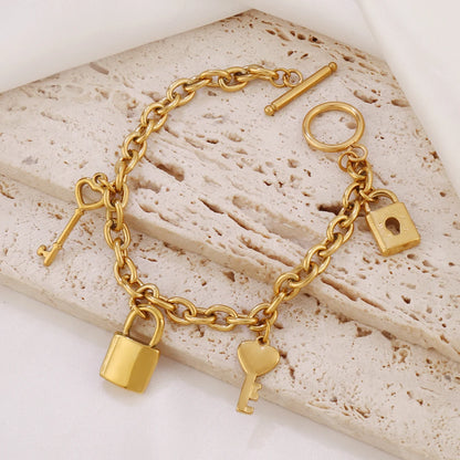 Bracelet breloques avec cadenas doré à bascule