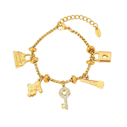Bracelet à breloques doré avec clips et clé brillante