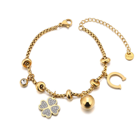 Bracelet à breloques doré avec trèfles et grelots