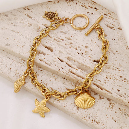 Bracelet breloques avec étoile de mer doré à bascule
