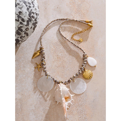 Collier à breloques doré avec gros coquillage blanc