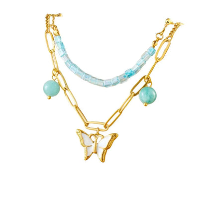 Collier à breloques doré papillon blanc et perles bleues