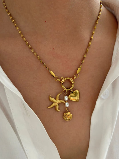 Collier à breloques étoile, coeur et grelot dorées