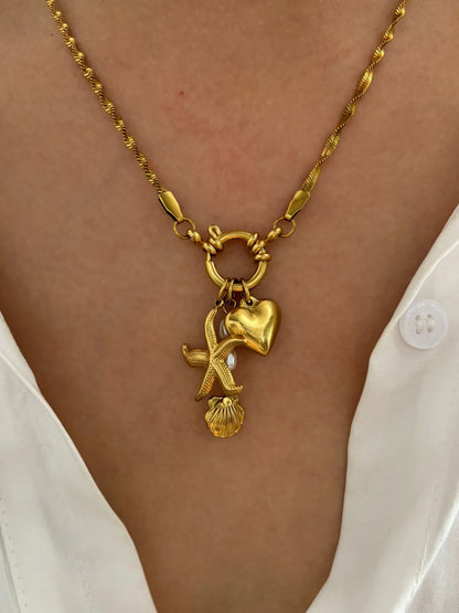 Collier à breloques étoile, coeur et grelot dorées