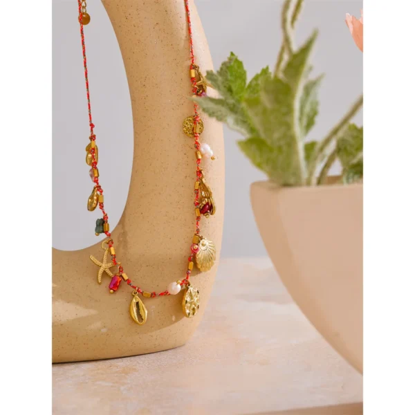 Collier breloques coquillages dorés